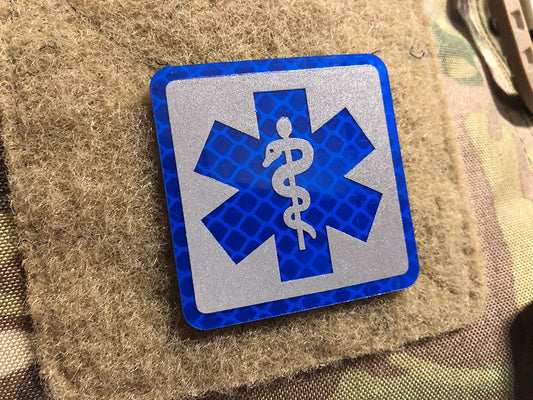 MEDIC Logo, blau und silber reflektierend, mit Klettrückseite